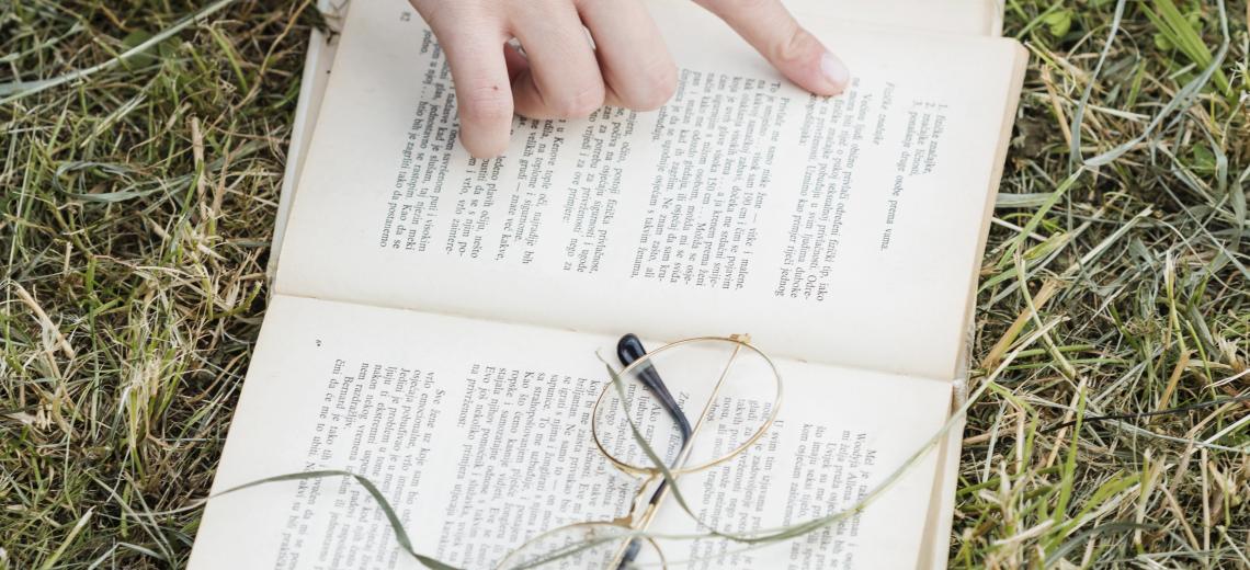 hand-pointing-open-book-grass © magnific