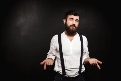 Young handsome man posing over black background. © magnific