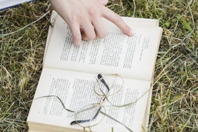 hand-pointing-open-book-grass © all rights reserved